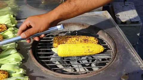 Cooking corn cobs on the grill on the market in Istanbul Stock Footage 56687384
