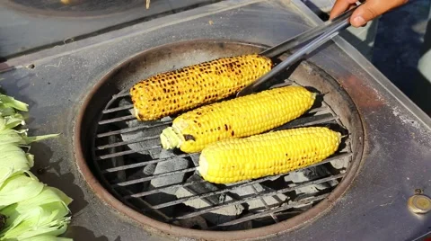 Cooking corn cobs on the grill on the market in Istanbul Stock Footage 56687397