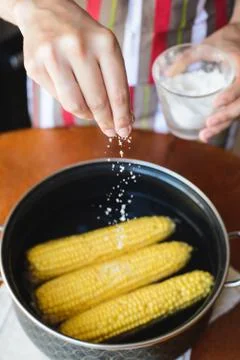 Cooking corn in a pan in the kitchen Stock Photos