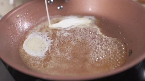 Cooking cream into the pan Stock Footage 127360169
