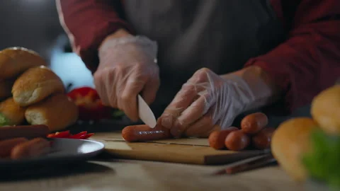 Cooking. Creative chef uses professional skills to cut sausage for cooking i Stock Footage 271154022
