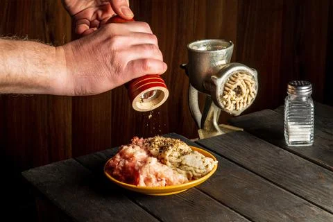 Cooking cutlets with the hands of a chef on a dark background. Stock Photos