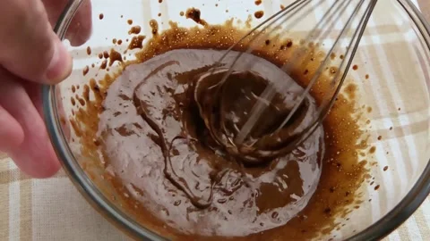 Cooking Dalgona coffee closeup. Hands whipping coffee with mixer. Slow motion Stock Footage 130738631