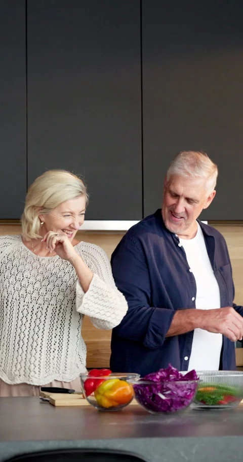 Cooking, dance and energy with old couple in kitchen of home together for Stock Footage 336856677