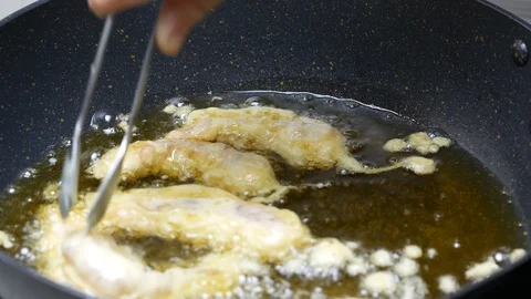Cooking deep batter-fried prawns , put shrimps with flour powder into the boi Stock Footage 89749458