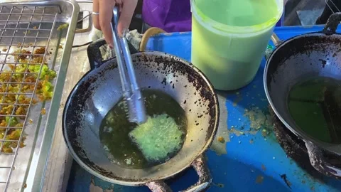 Cooking Deep Fried Thai Pandan Green Rice Flour Pancake, Street Food Dessert Stock Footage 233229381