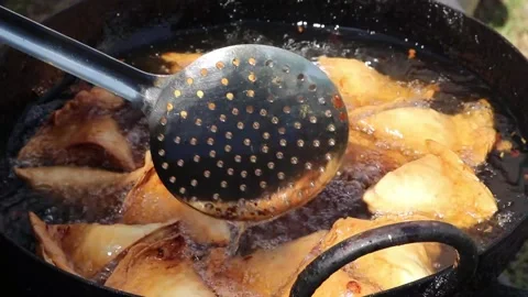 Cooking Deep Frying And Steering Popular Snacks Samosa In Hot Boiling Oil Stock Footage 149947391