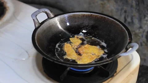 Cooking delicious fried tempeh fried in a frying pan filled with oil Stock Footage 282065500
