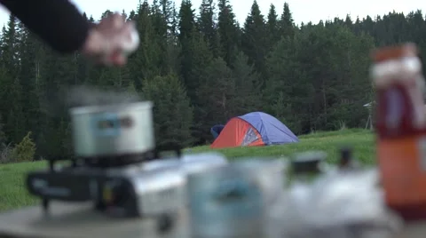 Cooking Dinner at the Campsite 4K Stock Footage 63920292