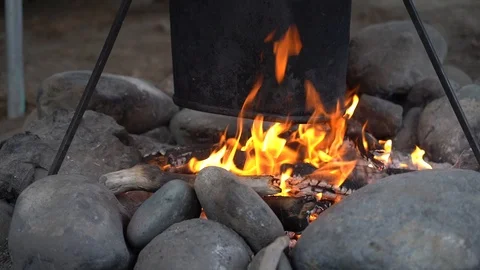 Cooking dinner or tea with open fire. Burning firewood and smoke. Halt and rest  Stock Footage 112803594