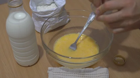 Cooking dough for pancakes. Adding salt Stock Footage 115476185