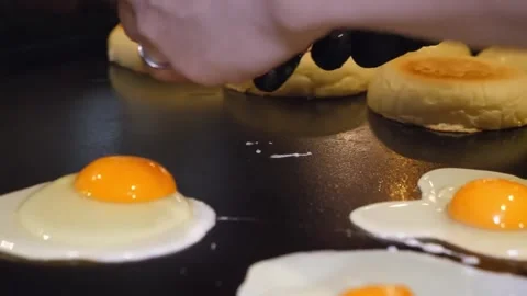 Cooking Eggs and Buns on a Flat Top Griddle Stock-Footage 347689556