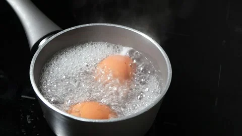 Cooking eggs in boiling water for perfect results Stock Footage 321107491