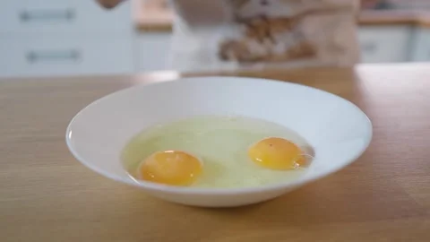 Cooking eggs. Cracking and beating eggs. Useful food. Chicken eggs. Stock Footage 276294199