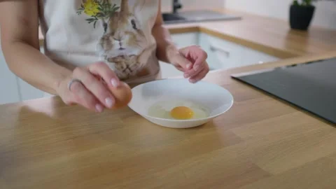 Cooking eggs. Cracking and beating eggs. Useful food. Chicken eggs. Stock Footage 276294366