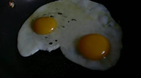 Cooking eggs fast motion Stock Footage