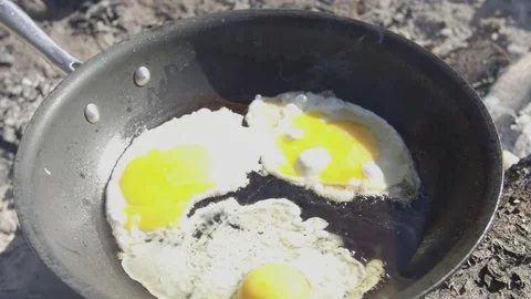 Cooking Eggs On Pan Over Camp Fire 2 Stock Footage 79000411