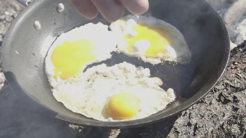 Cooking Eggs On Pan Over Camp Fire 1 Stock Footage 79001660