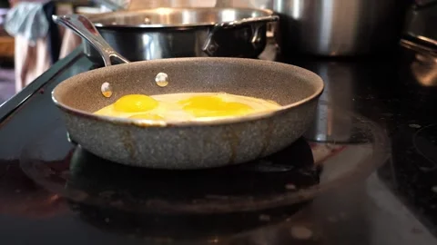 Cooking eggs in a pan side view slow motion Stock-Footage 280143558