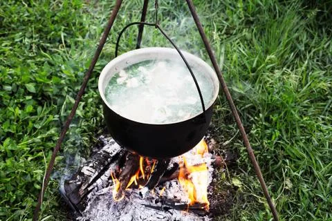 Cooking on a fire in a boiler in the field Foto stock