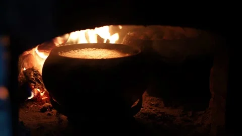 Cooking on the fire of a home rustic oven chowder soup in a pot. Stock Footage 151287374