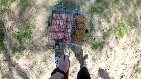 Cooking on fire outdoors Video stock 241309153