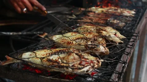 Cooking fish and roasting marinated fish... | Stock Video | Pond5