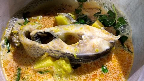 Cooking fish curry with pumpkin2 Stock Footage 318113814