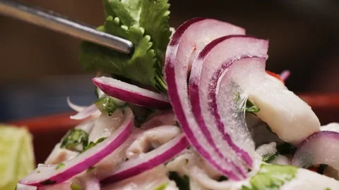 Cooking fish Peruvian ceviche close-up. Fresh cooked ceviche made of raw white Stock Footage 289658605