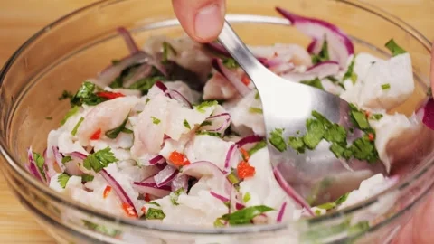 Cooking fish Peruvian ceviche close-up. Fresh cooked ceviche made of raw white Stock Footage 289658832