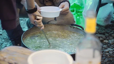 Cooking fish soup on a campfire Video stock 120494831