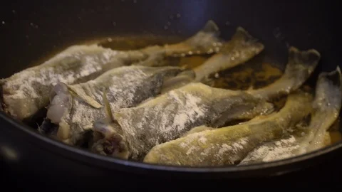 Cooking fish in two pans Stock Footage 125009498