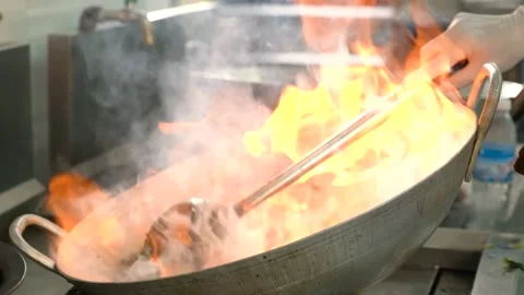 Cooking With Flame In A Frying Pan Stock Footage 173373695