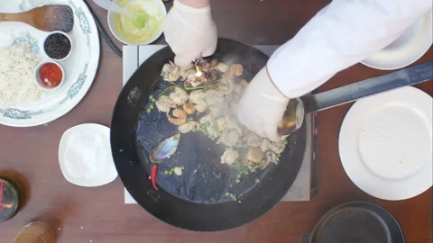 Cooking with flame in a frying pan on a kitchen stove Stock Footage 121985923