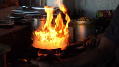 Cooking Flame Rising from Pan in Kitchen Scene Stock Footage 333594878