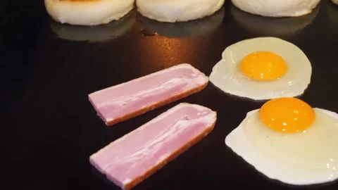 Cooking on a Flat Top Griddle with Eggs, Bacon, and English Muffins Video stock 347689552