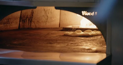 Cooking Flatbread in Fire Oven Stock-Footage 129847078
