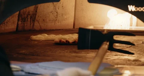 Cooking Flatbread in Fire Oven Stock-Footage 129848066