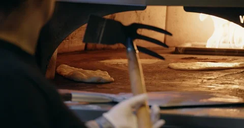 Cooking Flatbread in Fire Oven Stock-Footage 129848375