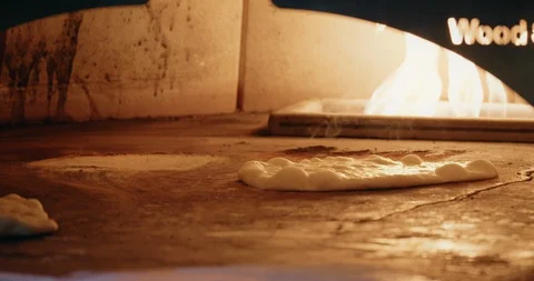 Cooking Flatbread in Fire Oven Stock-Footage 129848862