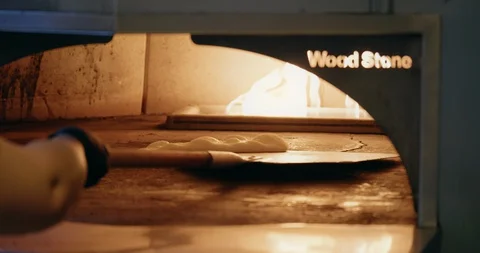 Cooking Flatbread in Fire Oven Stock-Footage 129849403