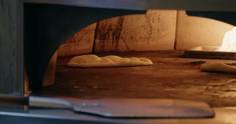 Cooking Flatbread in Fire Oven Stock-Footage 129849798