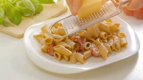Cooking, food and home male hands grating cheese over hot pasta Stock Footage
