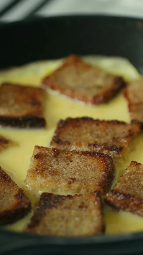 Cooking french toast bread pudding in skillet Stock Footage 337830556