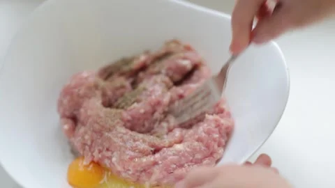 Cooking fresh minced meat, adding eggs and spices Stock Footage 256880486