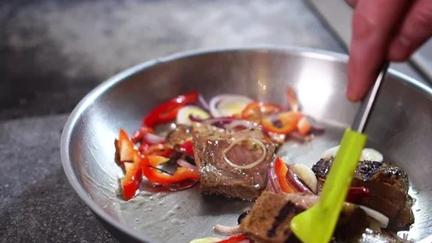 Cooking fresh vegetables with beef steak meat on hot frying pan in slow motion Stock-Footage 105457784