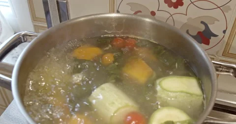 Cooking fresh vegetables into a boiling pot- 4k extreme close up slow motion Stock Footage 151641759