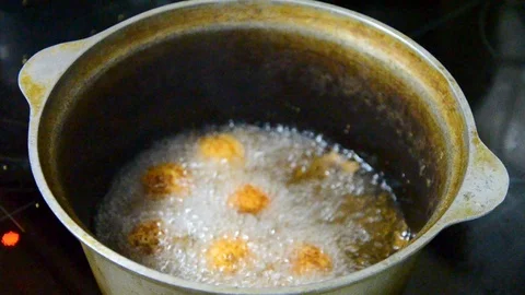 Cooking fried cheese balls - in a cauldron Stock Footage 114612432
