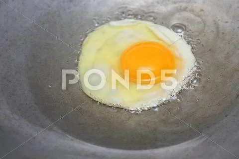 Cooking Fried Egg In Hot Pan With Oil