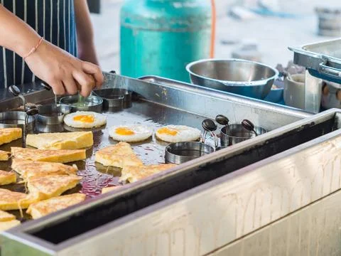 Cooking fried egg in shape form Stock Photos